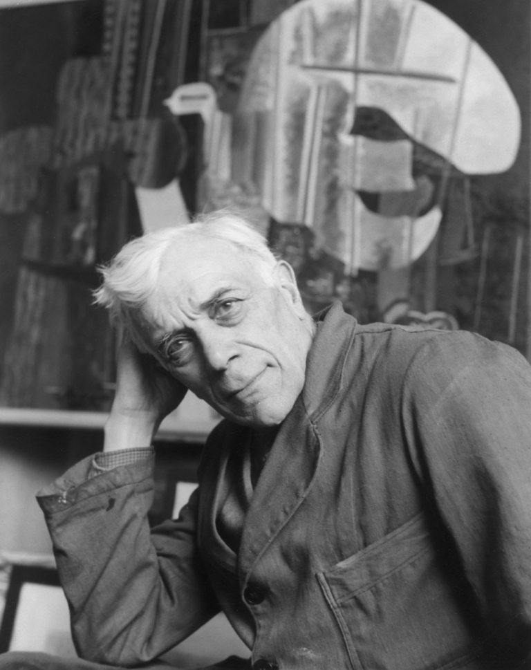 circa 1945: Portrait of French painter Georges Braque (1882 - 1963), co-founder of the Cubist movement in modern art, wearing a painter's smock and leaning his head on his hand. (Photo by Hulton Archive/Getty Images)